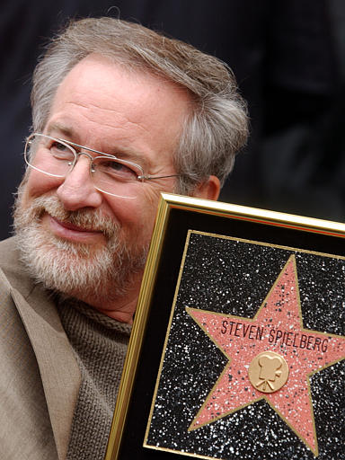 Film director Steven Spielberg holds up a replica of his new star on the Hollywood Walk of Fame in Los Angeles, January 10, 2003.